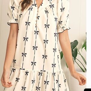 Cream Boutique Dress with Black Bow Pattern